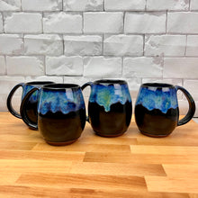 Load image into Gallery viewer, Aurora Borealis Mugs. each one is different. northwest style coffee mug thrown Red Stoneware, with large pulled handle. black glaze base with swirls of blue, turuoise, and hints of purple, reminiscent of the Aurora Borealis.