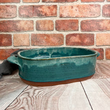 Load image into Gallery viewer, Casserole dish in Teal glaze with Iced rim. wheel thrown and altered, with pulled handles added. made with stoneware clay.
