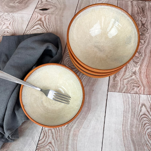 set of four stacking bowls, perfect size for soup, cereal, salad, or ice cream. These bowls are glazed with a Glossy, speckled, white glaze inside and feature the red-brown exposed stoneware clay on the exterior.
