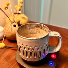 Load image into Gallery viewer, carved mug, wheel thrown and hand carved, in a cup warmer.