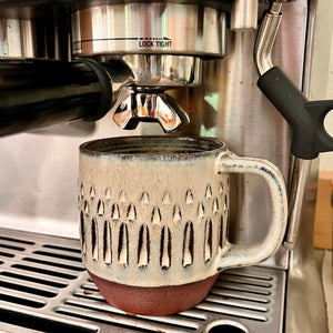 Hand carved, artisan made, wheel thrown pottery mug, shown here in a Breville Espresso machine.