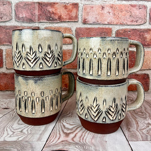 stackable carved coffee mugs with verticla pattern and tree pattern. hand carved artisan made mug by Meredith Chernick