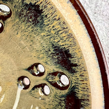 Load image into Gallery viewer, Close up of berry colander. Wheel thrown pottery, red stoneware shown in Caramel glaze.
