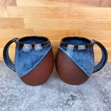 Load image into Gallery viewer, Wheel thrown and hand crafted in red-brown stoneware clay, these angle dipped mugs are featured in a drippy icy blue glaze which shows a lot of color variation, as well as the rich brown clay beneath. beautiful color and textures. holds 14-16 oz. Fern Street Pottery. Angle dipped mug.
