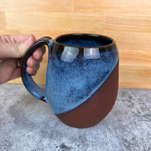 Load image into Gallery viewer, Wheel thrown and hand crafted in red-brown stoneware clay, this angle dipped mug is featured in a drippy icy blue glaze which shows a lot of color variation, as well as the rich brown clay beneath. beautiful color and textures. holds 14-16 oz. Fern Street Pottery. Angle dipped mug.