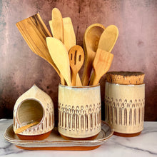 Load image into Gallery viewer, utensil holder, wheel thrown stoneware, handcarved texture. red clay with speckled white glaze. shown here paired with matching salt cellar, tray, and canister. (all sold separataely)