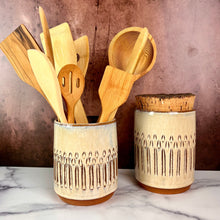 Load image into Gallery viewer, utensil holder, wheel thrown stoneware, handcarved texture. red clay with speckled white glaze. shown here with a matching canister.