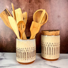 Load image into Gallery viewer, Canister (Medium size) for beautiful display and storage. this canister is wheel thrown from red stoneware clay, carved with a pattern and glazed in a speckled white glaze. the canister has a natural, rough cork lid. shown here with a matching utensil holder, sold separately.