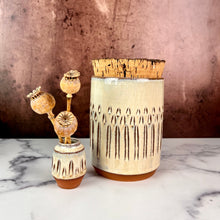 Load image into Gallery viewer, Canister (Medium size) for beautiful display and storage. this canister is made from red stoneware clay, carved with a pattern and glazed in a speckled white glaze. the canister has a natural, rough cork lid. shown here with a mini bud vase, sold separately.