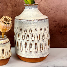 Load image into Gallery viewer, Bud vase thrown in red stoneware clay, carved and glazed in speckled white clay.