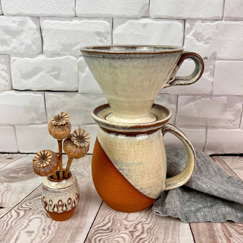 An angle dipped mug, pour over and vase  in red stoneware with speckled white glaze.