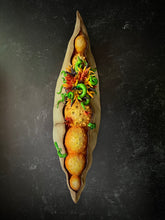 Load image into Gallery viewer, Seed Pod Sculpture, &quot;Sprouting Pod&quot;. Sculpted from stoneware it shows the dry outer husk in contrast with the vibrant blooming seeds which are growing and sprouting from within. shown on a dark background