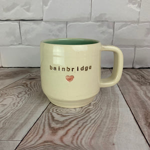 wheelthrown mug, says bainbridge and has a pink heart