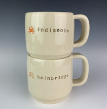Load image into Gallery viewer, two cylindrical mugs, wheel thrown, pottery, hand made and with city names pressed into them, and also a cute little image of a crab. 