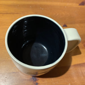 A wheel thrown mug shown with black glaze inside, Interior of a mug Glazed with the Glaze Splash Glaze Fountain