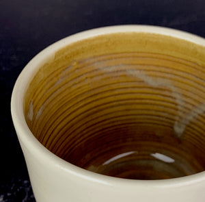 a custom mug shown with brown glazed Interior of a mug Glazed with the Glaze Splash Glaze Fountain