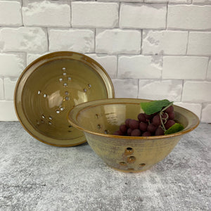 two 8" colanders in caramel.