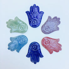 Load image into Gallery viewer, An array of Hamsas in a variety of colors, each one hand carved with an eye and a vine pattern, or a fish pattern. Cobalt Blue, Rose Pink, Lavender Purple, Celadon Green, Skye Blue. Fern Street Pottery