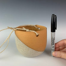 Load image into Gallery viewer, hangign planter with pen as reference  to show size. measures approximately 3.5-4 inches in any direction, with about 2 feet of hanging twine