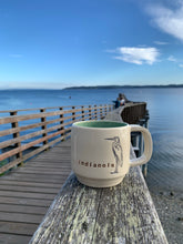 Load image into Gallery viewer, indianola mug, wheelthrown with great blue heron image and the word indianola inset. white exterior, glossy turquoise interior