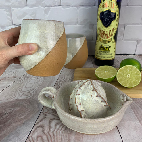 citrus juicer shown with tumblers, lime and tequila for margarita prep