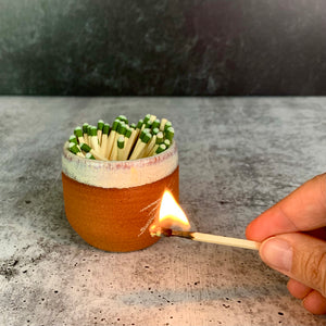 Pottery match striker in action made from stoneware. Strike on Pot with "Strike anywhere" matches. wheel thrown at Fern Street Pottery. 